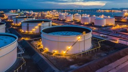 Aerial top view storage tank farm at night, Tank farm storage chemical petroleum petrochemical refinery product at oil terminal, Business commercial trade fuel and energy transport by tanker vessel.