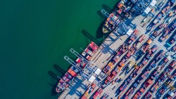 Container cargo ship loading at port, Freight transportation import export and business logistic by container ship, Aerial view.