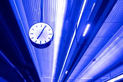 Street clock. On the ceiling with neon lights. Details Architecture