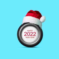 Car wheel, 2022, Santa Claus hat. Abstract new year concept Isolated on a blue background. Design element. Greeting card for auto repair shop, auto shop, auto mechanic. Festive background.