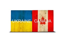 Flags of Ukraine and Canada on wooden blocks. Isolated on white background. Commonwealth. Support. Cooperation. Politics. Economy.
