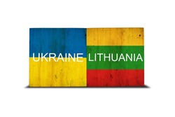 Flags of Ukraine and Lithuania on wooden blocks. Isolated on white background. Commonwealth. Support. Cooperation. Politics. Economy.