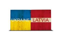 Flags of Ukraine and Latvia on wooden blocks. Isolated on white background. Commonwealth. Support. Cooperation. Politics.