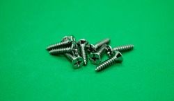 set of wood screws on a green background