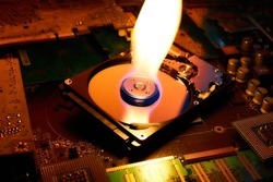 The flame is on the hard disk drive that lies on the printed circuit boards.