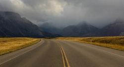 Highway through mountains landscape at overcast day. Horizontal shot. Travel photo, nobody, copy space for text