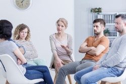 Separated couple and their young adult children resolving family issues in group therapy