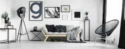 Artist's living room in minimal style with artworks 