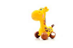 Mechanical wind up giraffe toy. Clockwork plastic toy isolated on white background.