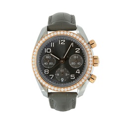 Luxury steel watch with rose gold and diamonds and with a black strap, front view isolated on white background