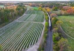 aerial view of train near farmland in spring