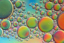 Trippy psychedelic abstract formed by oil droplets floating on water