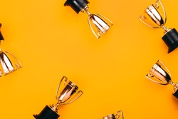 Winner or champion cup on bright background, Flat lay style. Open composition.