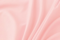 Close-up delicate pink silk fabric background. Empty space for text. Flat lay top-down