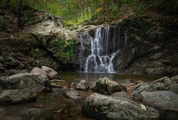 An image of Cascade Falls with rocks in the foreground at Patapsco State Park Avalon area.