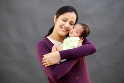Cheerful mother and newborn baby