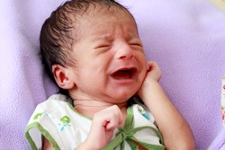 Crying newborn baby close up