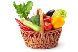 fresh and ripe vegetables arranged in a basket isolated on white