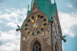 Clock wall on the tower of the ancient building in the city center of Zurich, Switzerland. Fraumunster church