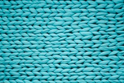 Texture of blue big knit blanket. Large knitting. Plaid merino wool. Top view