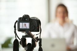Professional dslr digital camera filming live video blog interview or vlog of woman vlogger coach giving business class or presentation training people online, making videoblog and vlogging concept