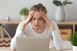 Stressed frustrated young woman student looking at laptop reading bad email internet news feeling sad tired of study work online, upset about problem, failed exam test results, difficult learning