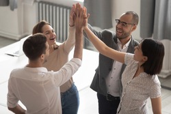 Happy motivated diverse business work team people employees group giving high five together engaged in teambuilding celebrate success good teamwork result shared win promise trust integrity concept