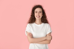 Isolated happy confident millennial girl standing with crossed hands, looking at camera, posing on pink background portrait. Young professional, employee, couch, tutor or trainer presentation.