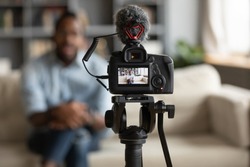 African man blogger sit on sofa record new vlog view through digital camera screen close up. Vlogger share new information with subscribers using modern digital equipment webinar videovlogging concept