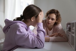 Strict mother scolding upset depressed teenage daughter for bad marks or school exam results, angry mum lecturing lazy unmotivated teen girl, generations, parent and child conflict