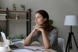 Pensive young Caucasian woman distracted form computer work read letter thinking pondering of problem. Thoughtful millennial female receive unpleasant news in document paperwork, make decision.