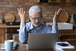 Annoyed worried aged man pensioner sit by laptop unable to make utility bill loan payment online has question how to use app need help. Stressed old grandpa confused with unexpected debt on pc screen