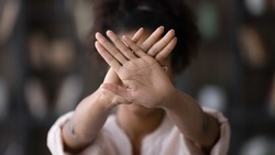 African American young woman show stop or no hand gesture or sign protest against racial or gender discrimination. Biracial female demonstrate object against domestic violence or abortion.