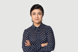 Portrait of young successful Indian woman worker employee stand isolated on grey studio background feel confident. Millennial mixed race female intern show motivation. Employment, hr concept.