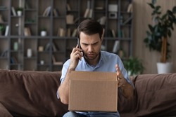 Stressed male client arguing with internet store manager, feeling dissatisfied with received item or crashed goods in carton box, complaining about awful shipping service, negative shopping experience