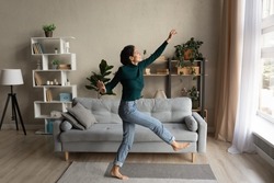 Wonderful life. Overjoyed happy millennial hispanic woman dance at modern living room in playful mood enjoy weekend leisure time. Carefree young lady having fun celebrate freedom after cleaning home