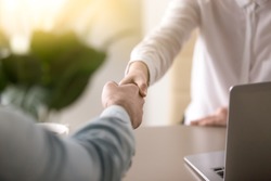 Close up of a handshake, male and female hands shaking as a symbol of effective negotiations, making agreement, greeting business partner or mutual respect and gender equality in relationships 