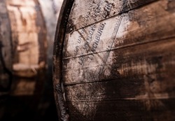 whiskey barrels aging in a distillery rack house.