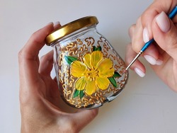 Master class on stained glass painting on a small ceramic jar with a brush, drawing school. Hobbies for women, housewives, children. Flower pattern, gold ornament, handmade