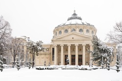 Bucharest, Romania - January 17: University Square on January 17, 2016 in Bucharest, Romania. The Romanian Athenaeum George Enescu Ateneul Roman opened in 1888 is a concert hall in the center