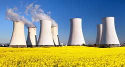 Panoramic view of Nuclear power plant Jaslovske Bohunice with golden flowering field of rapeseed - Slovakia - two possibility for production of electric energy