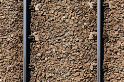 Railway top view background. Train transport industry. Rail track texture. Good and cheap way of transportation for cargo. Old railroad wooden tie. Track ballast gravel made of crushed stone.