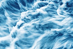 Water motion background. Abstract foam smudges texture. Turbulent river flow. Waterfall closeup.