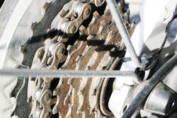 Bicycle casette background. Metal bike part. Dusty and dirty gearwheel closeup. Used bicycle sprocket and chain.