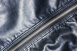 Metal zipper background. Black leather jacket. Autumn and winter fashion texture. Closed fastener. Zipped zipper. Fabric design pattern. Closeup clothing zipper.