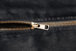 Plastic zipper background. Dark black coat zipper. Empty copy space fabric texture. Closeup zipper teeth. Metal shiny clothing part. Closeup zipped zipper.	