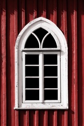 Mosque window. Muslim architecture. Peeling paint religious building. Oriental arch. Red color wooden wall.