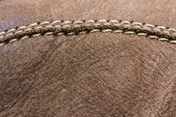 Brown suede shoe with stitch and sew macro closeup texture.