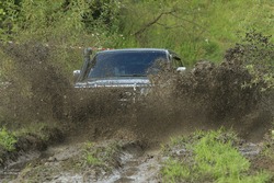 four-wheel dirve crosses the mud obstacle on the distance of racing