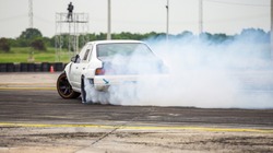 Car drifting, Car wheel spinning with smoke coming from wheels, Drag Racing on speed race track,